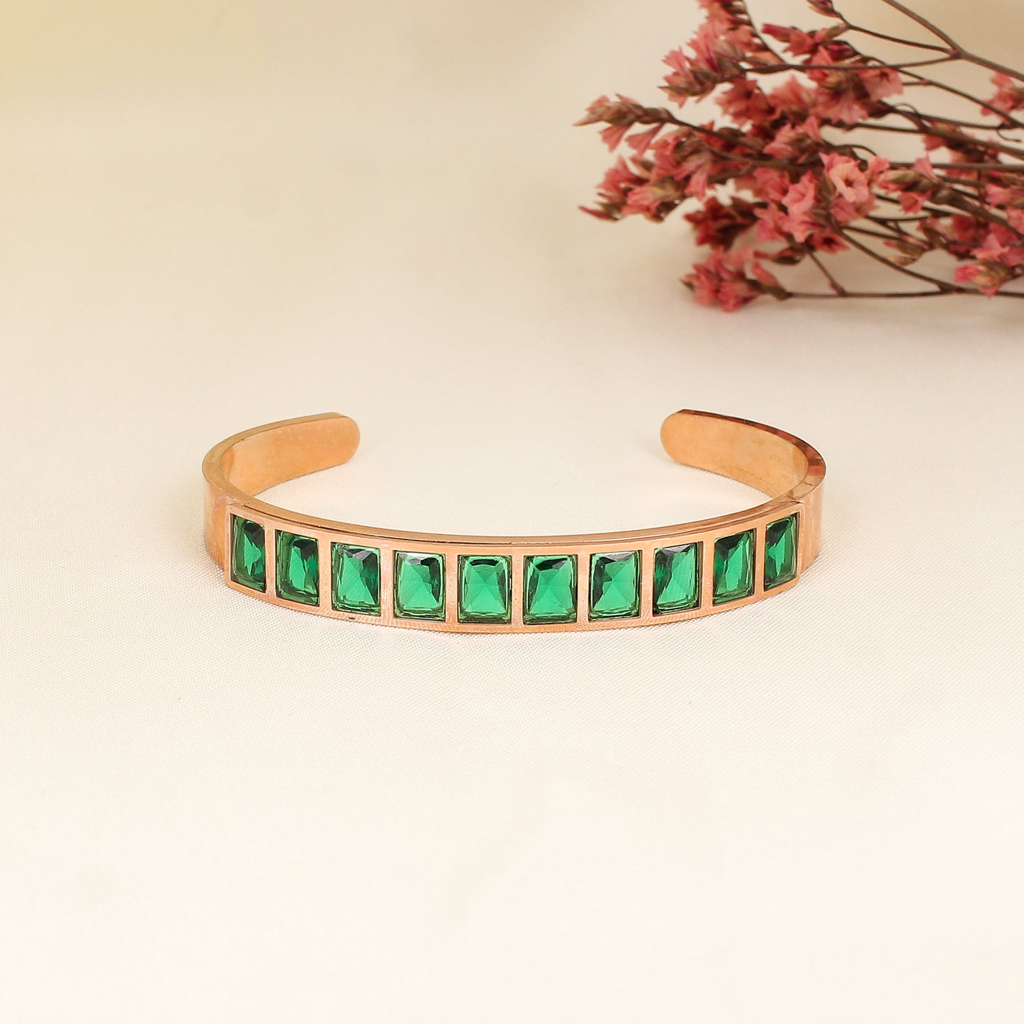 CKLAKART's Rose Gold Bracelet Featuring Dazzling Green Stones