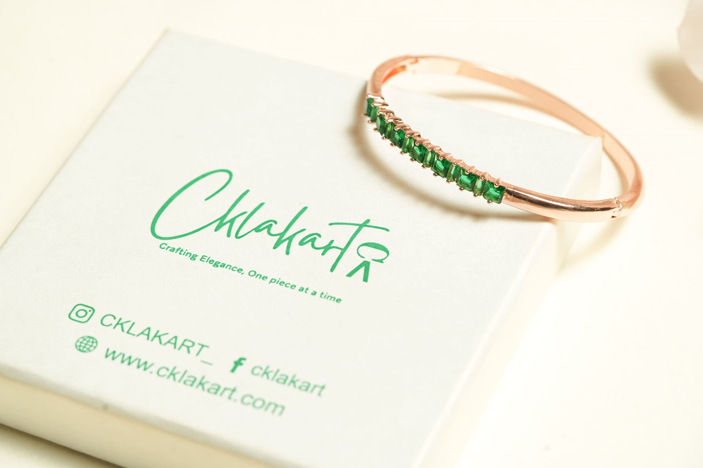CKLAKART's Rose Gold Bracelet with Mesmerizing Green Stone Adornments