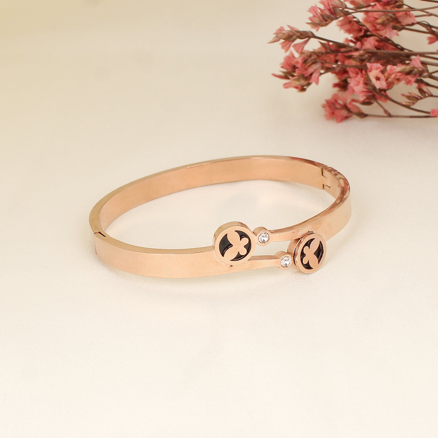 CKLAKART's Rose Gold Bracelet with White Stones and Butterfly Motif on Black
