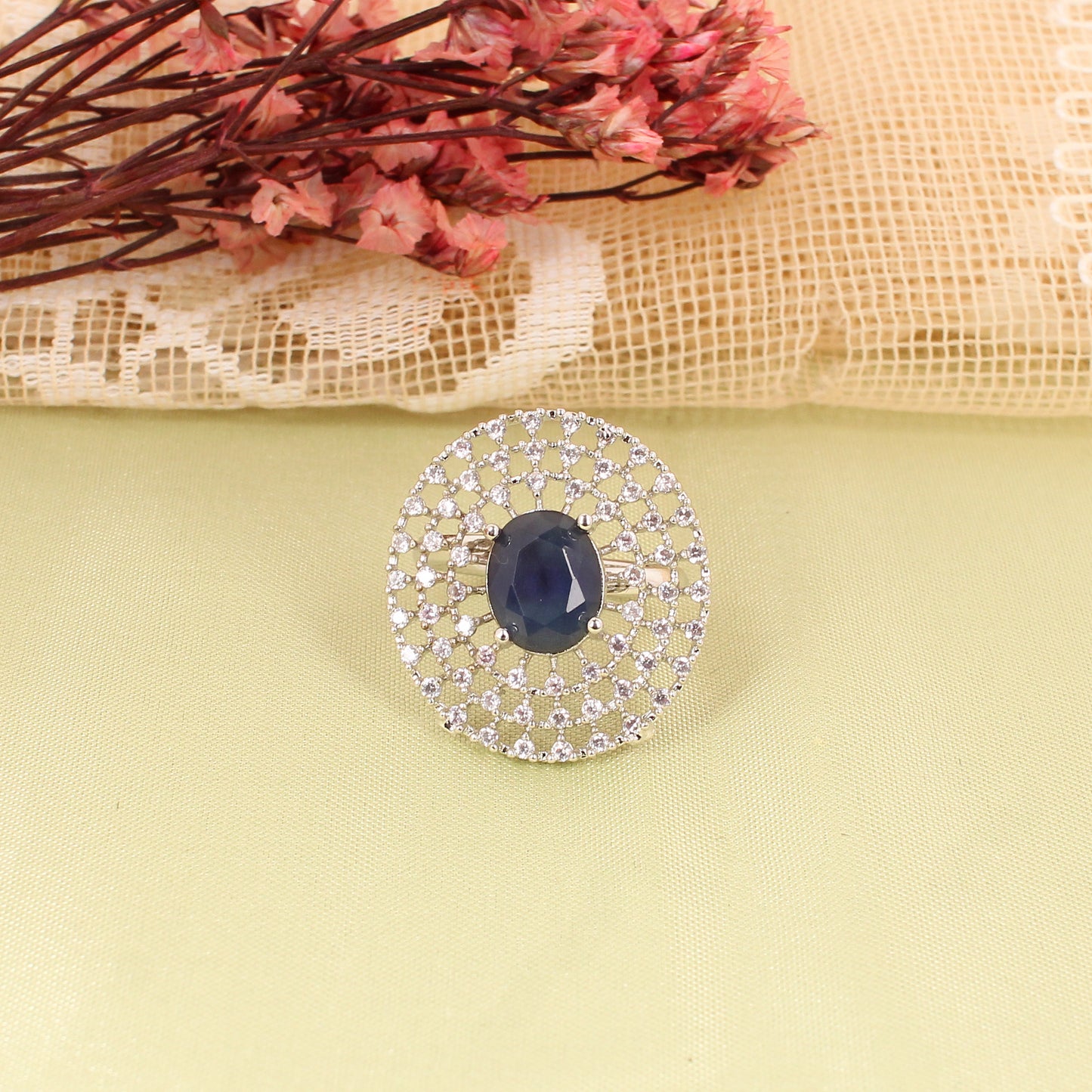 CKLAKART's Silver-Toned Oval Blue Sapphire Ring with Three Layers of White Stones