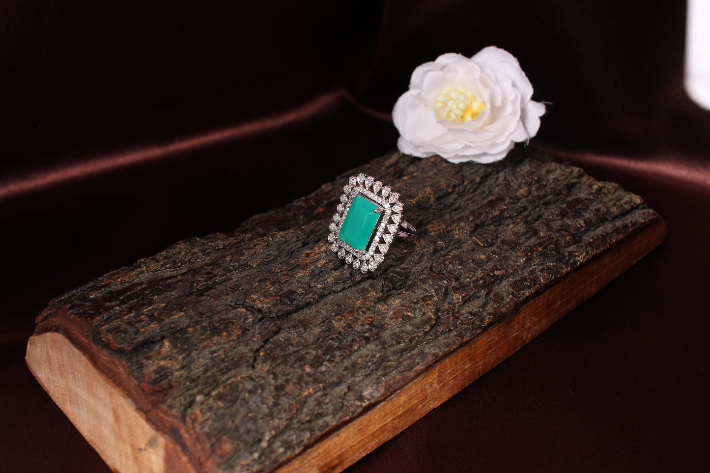 CKLAKART's Silver-Toned Statement Ring with Emerald Green Center and White Stone Embellishments