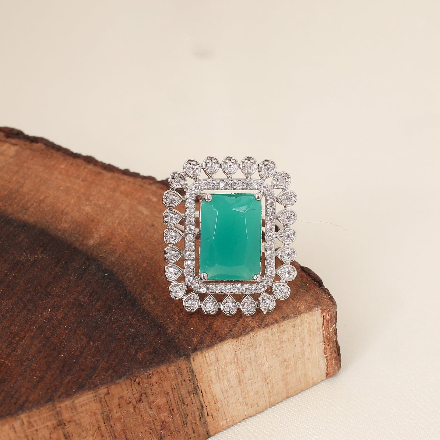 CKLAKART's Silver-Toned Statement Ring with Emerald Green Center and White Stone Embellishments