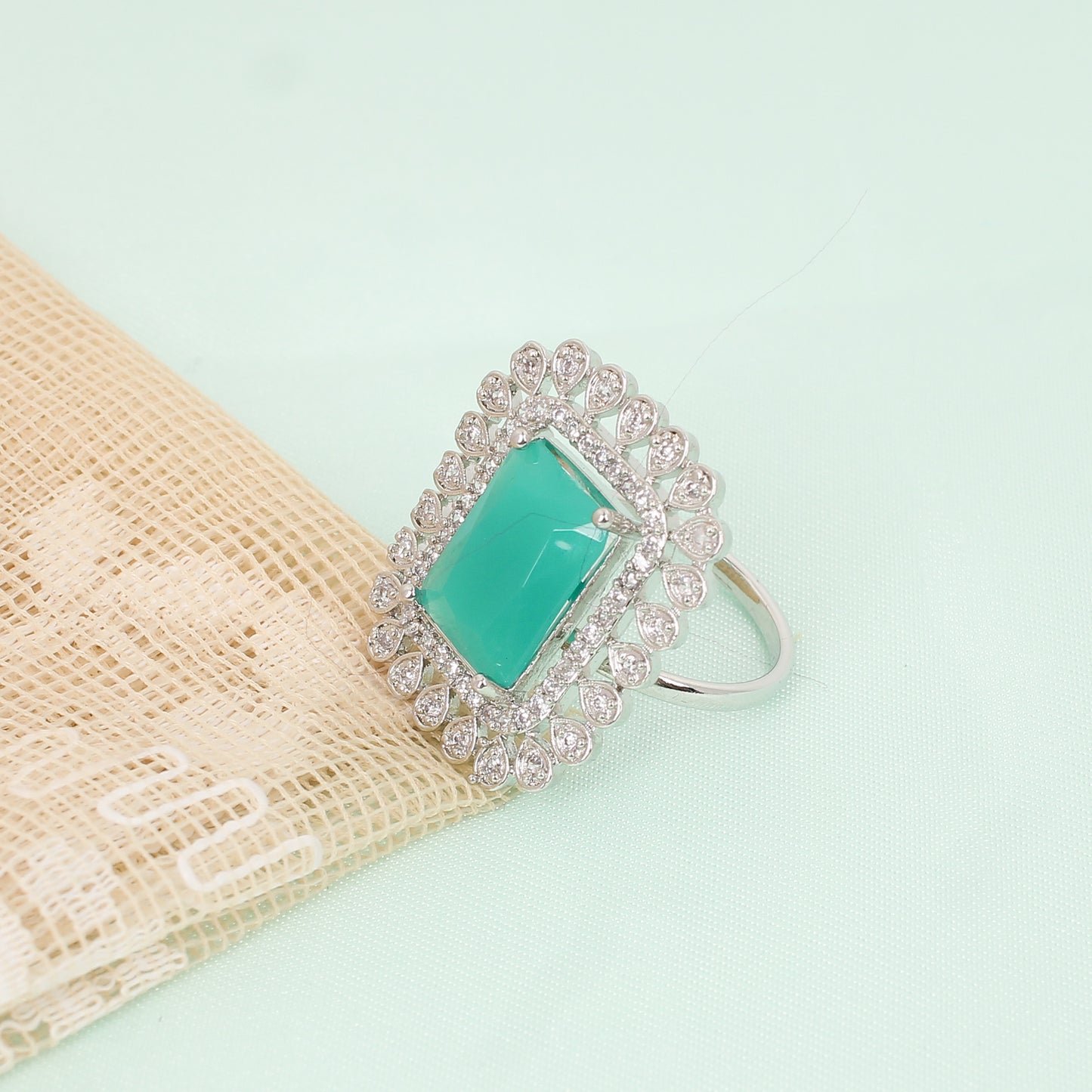 CKLAKART's Silver-Toned Statement Ring with Emerald Green Center and White Stone Embellishments