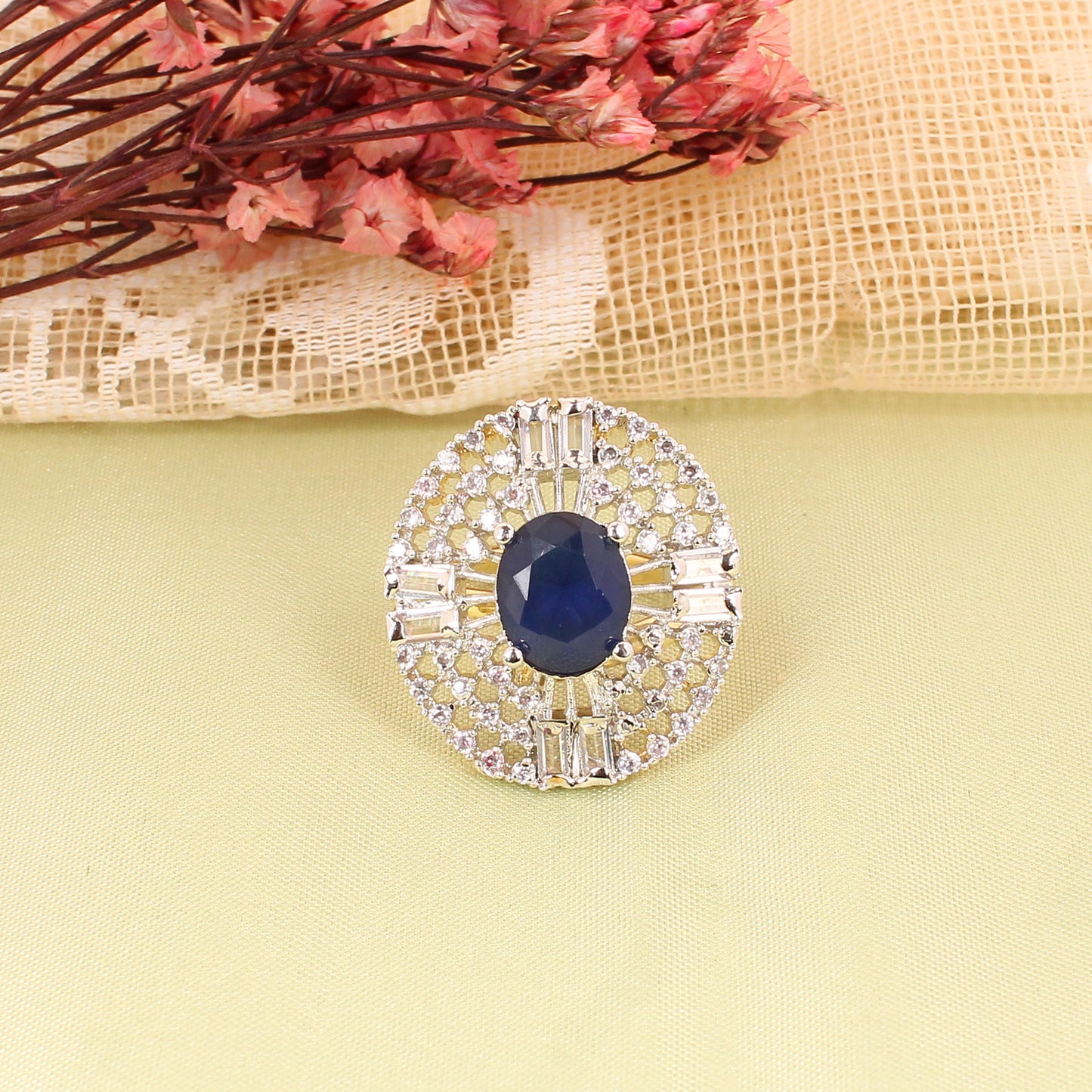 CKLAKART's Silver-Toned Big Ring with Oval Blue Sapphire and Surrounding White Stones