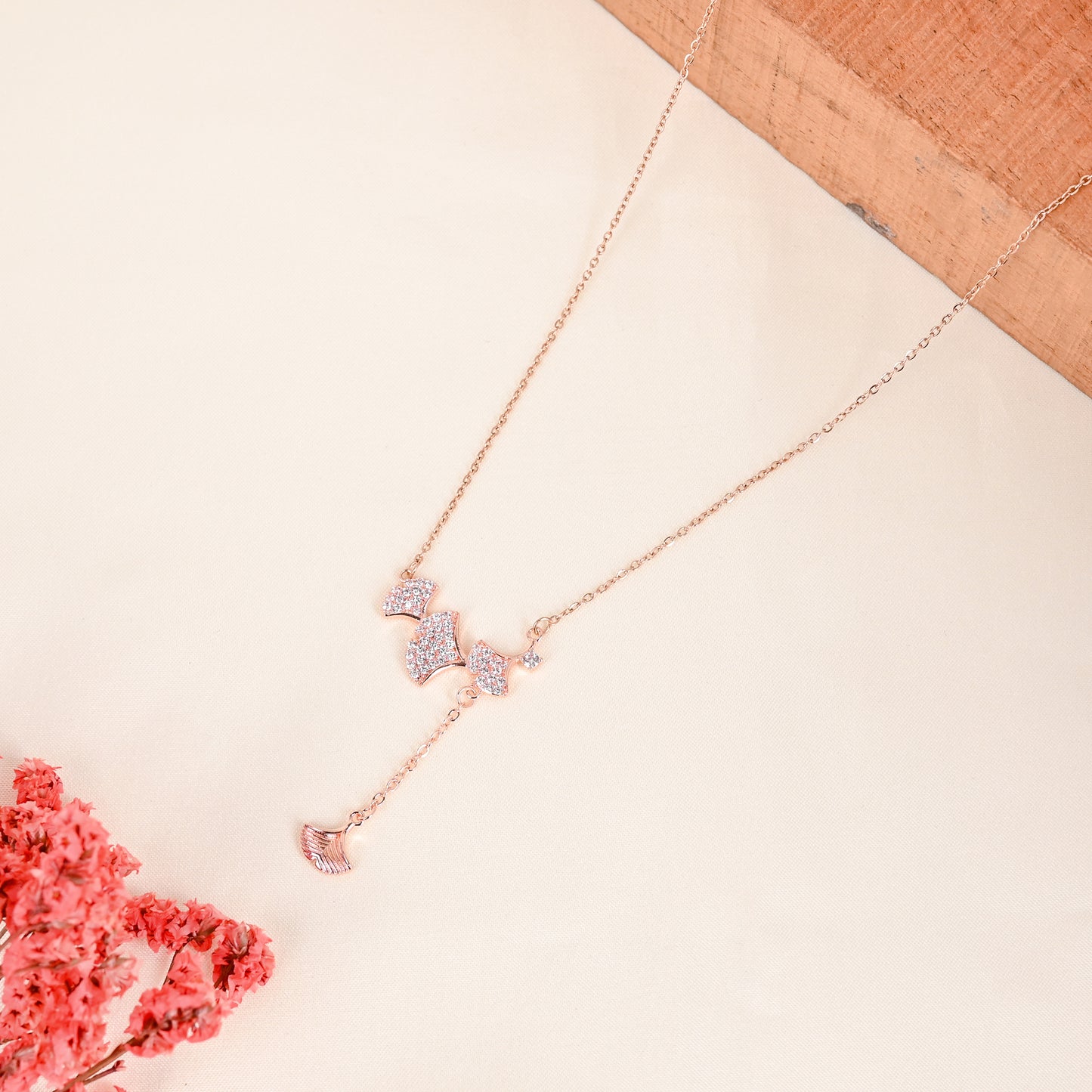 CKLAKART's Rose Gold Tone Petals Charm Necklace with Shimmering AD