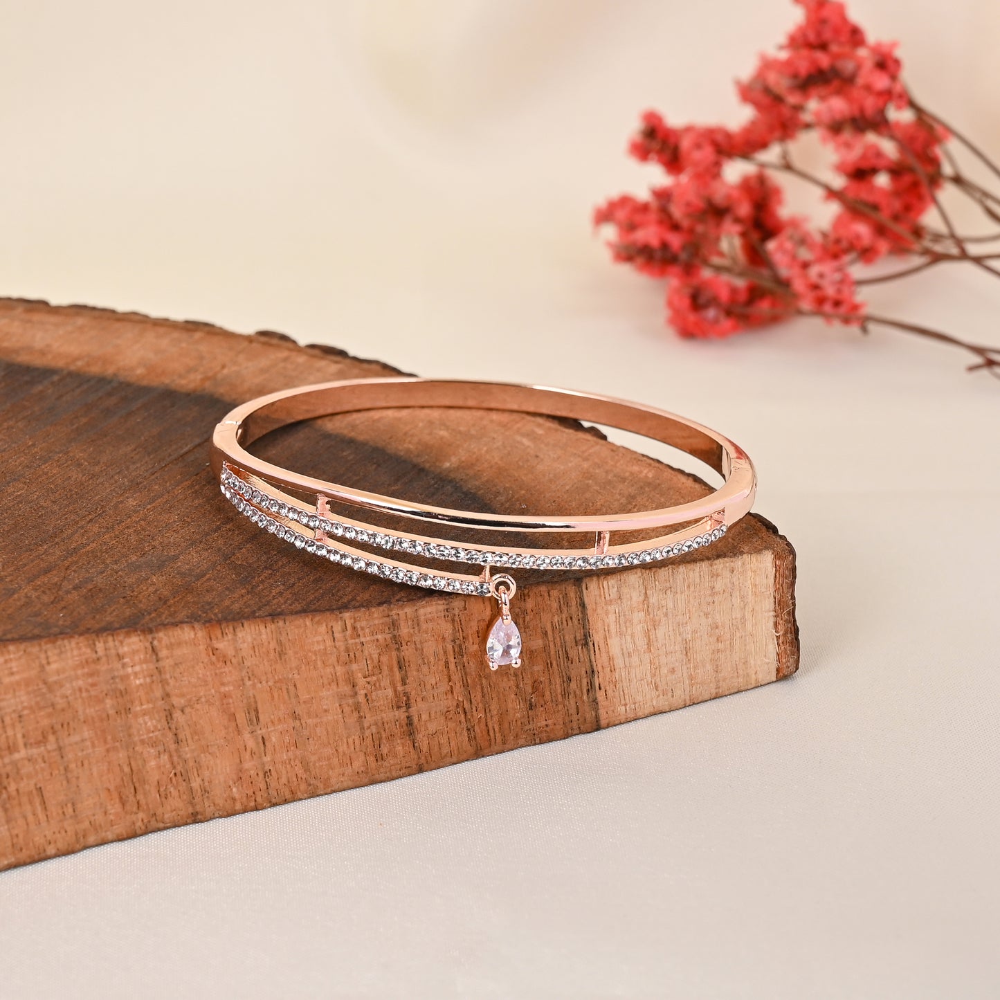 CKLAKART's Rose Gold Toned Triple Strand Bracelet with Delicate Droplet