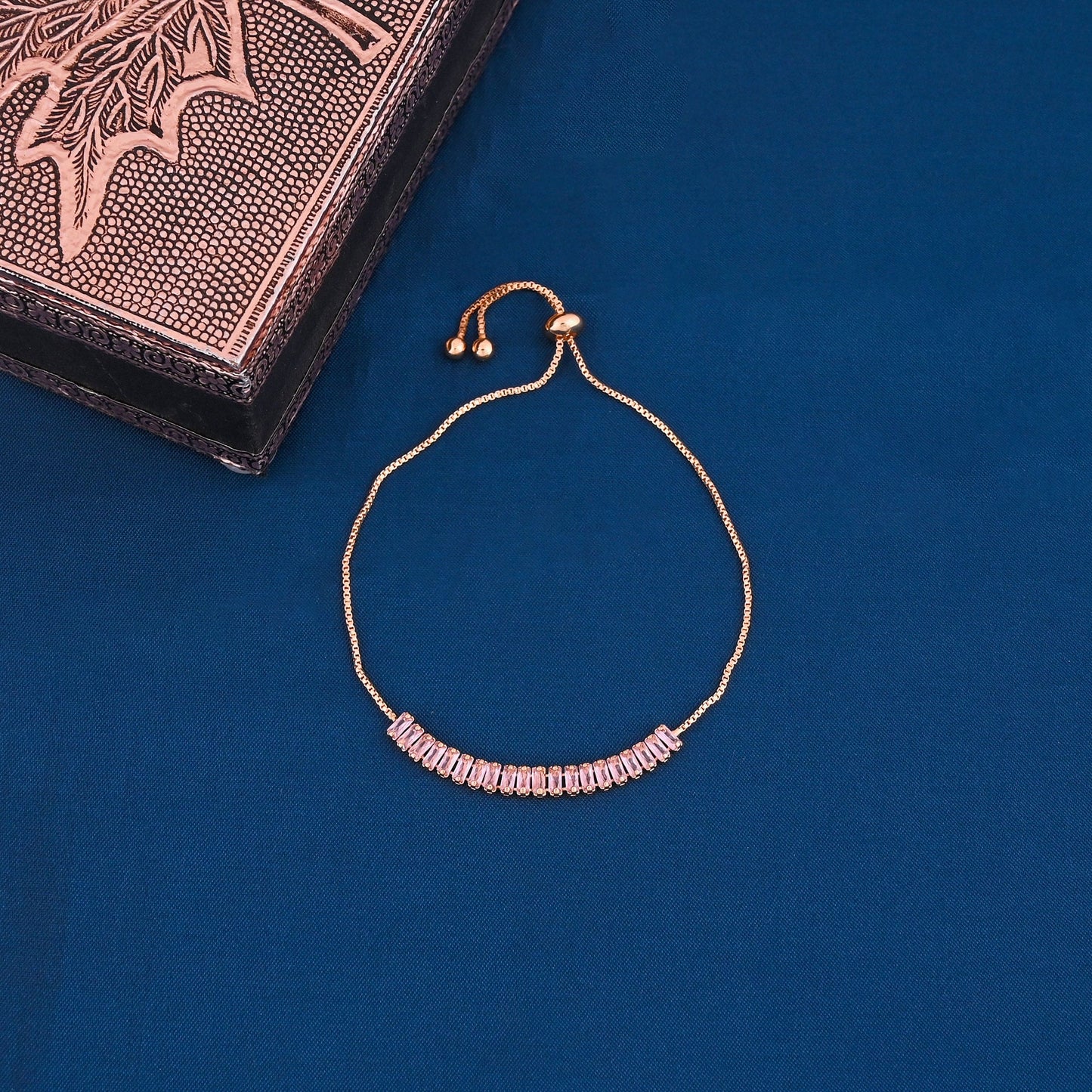 CKLAKART's Gold Toned Bracelet Adorned with Pink Stones