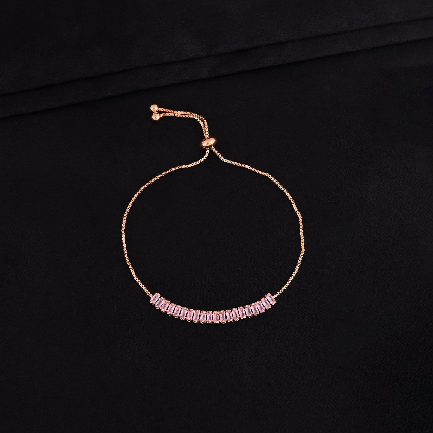 CKLAKART's Gold Toned Bracelet Adorned with Pink Stones