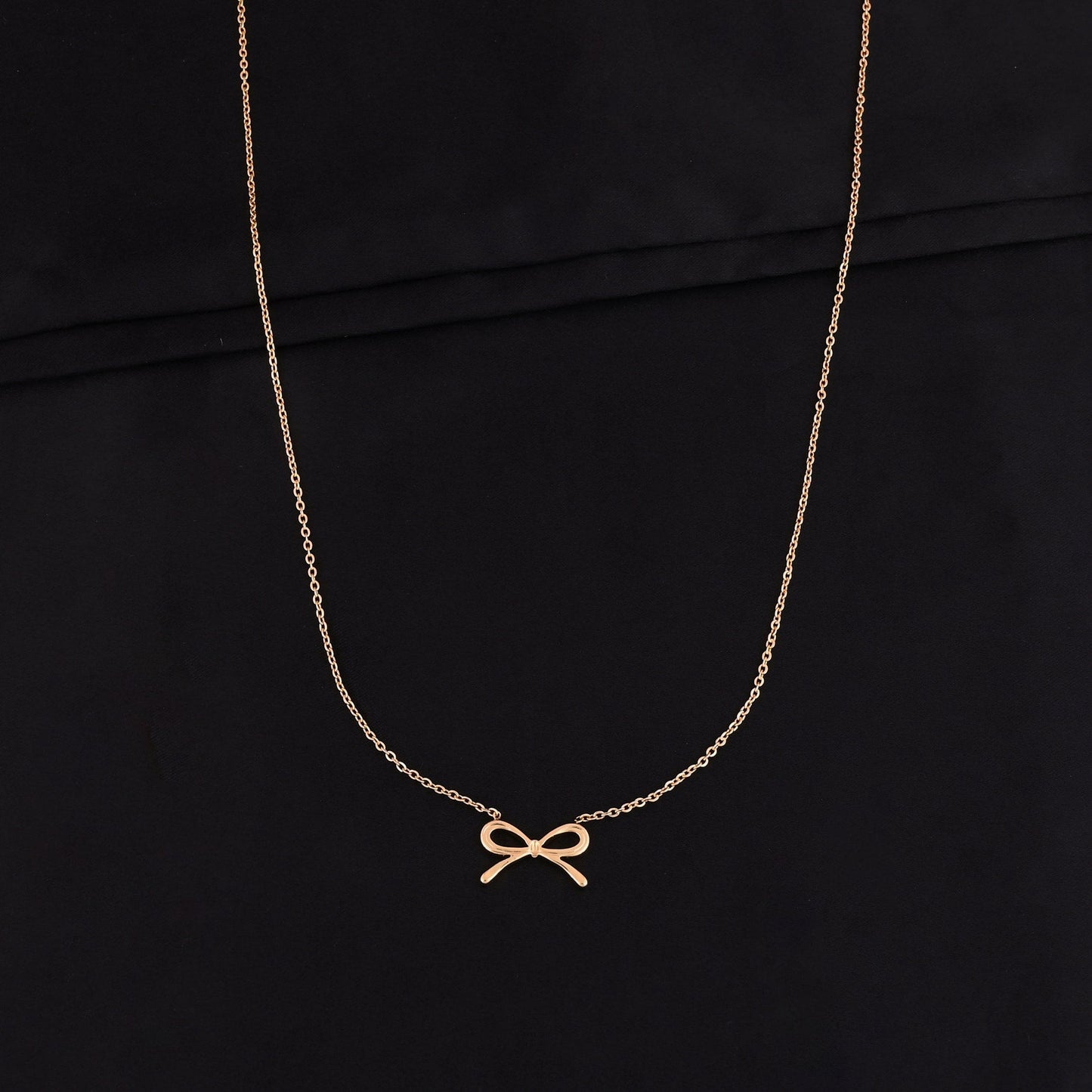 CKLAKART's Gold Tone Chain Necklace with Bow Pendant