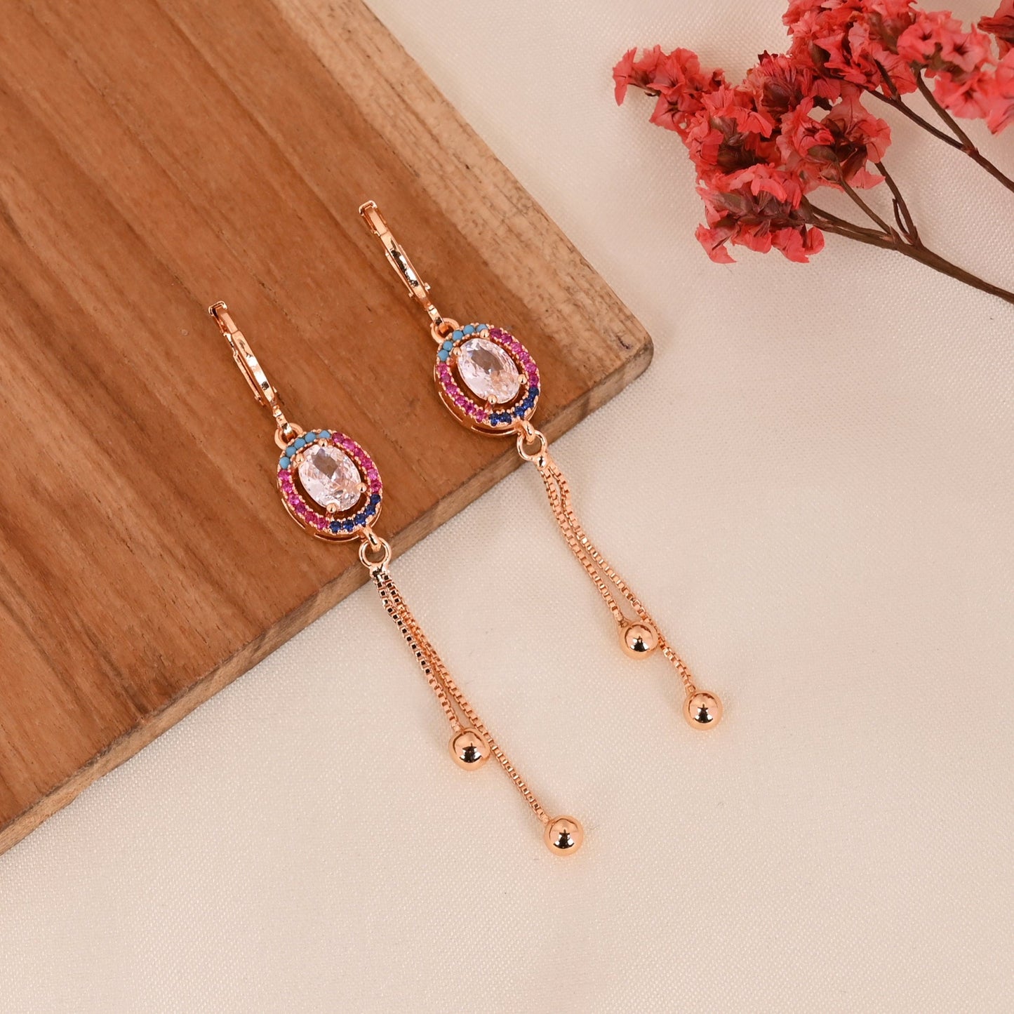 CKLAKART's Rose Gold Toned Earrings with Multi-Color AD Studded Ovals and Stylish Chain Accents