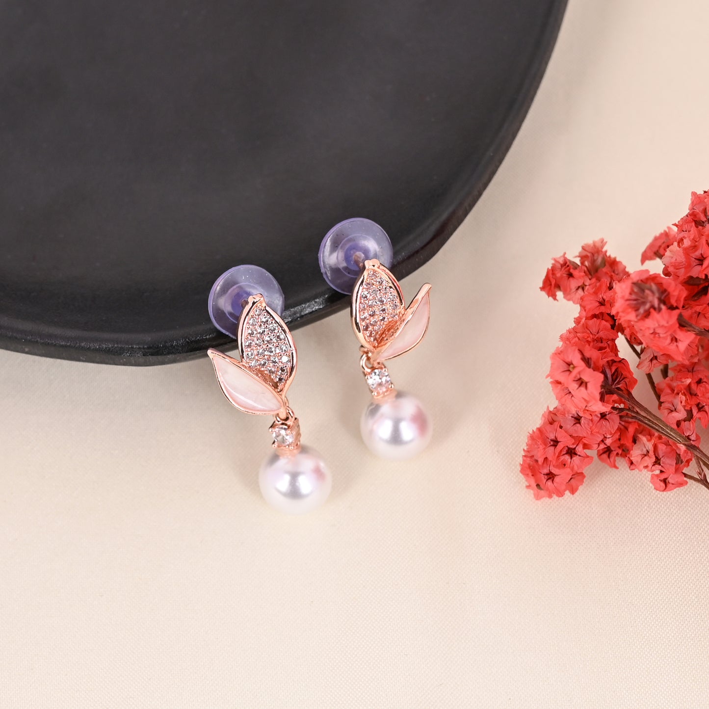 CKLAKART's Rose Gold-Toned Leaf Studs Featuring AD Stones and Delicate Pearl Drop