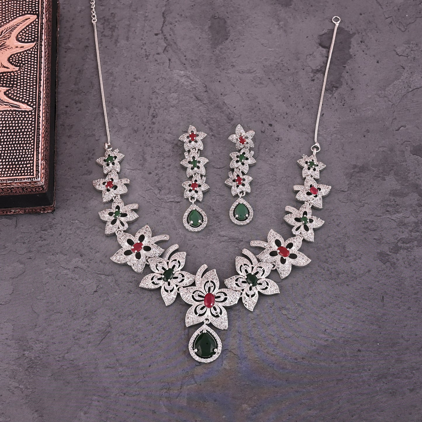 CKLAKART's NOOR Silver-Toned Floral Neckpiece Featuring Emerald Green, Ruby Stones, and American Diamond Sparkle