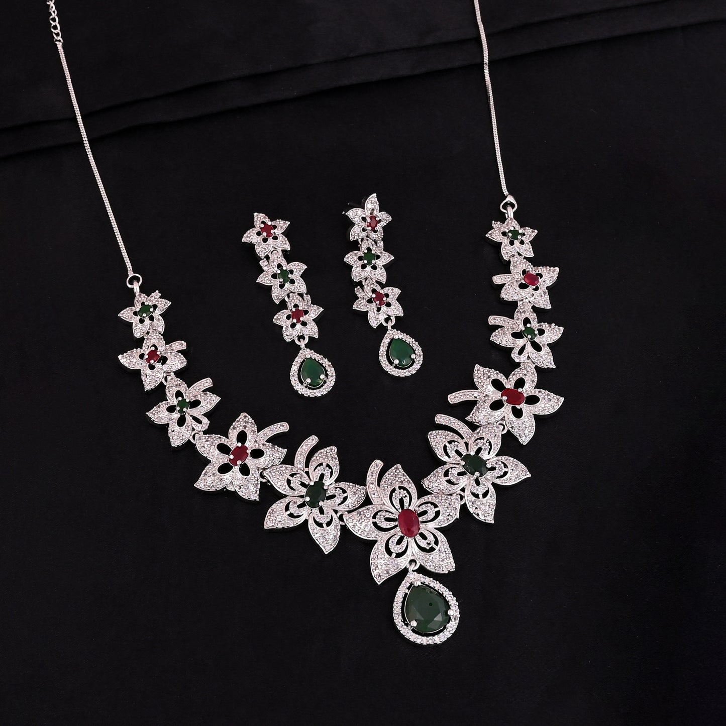 CKLAKART's NOOR Silver-Toned Floral Neckpiece Featuring Emerald Green, Ruby Stones, and American Diamond Sparkle