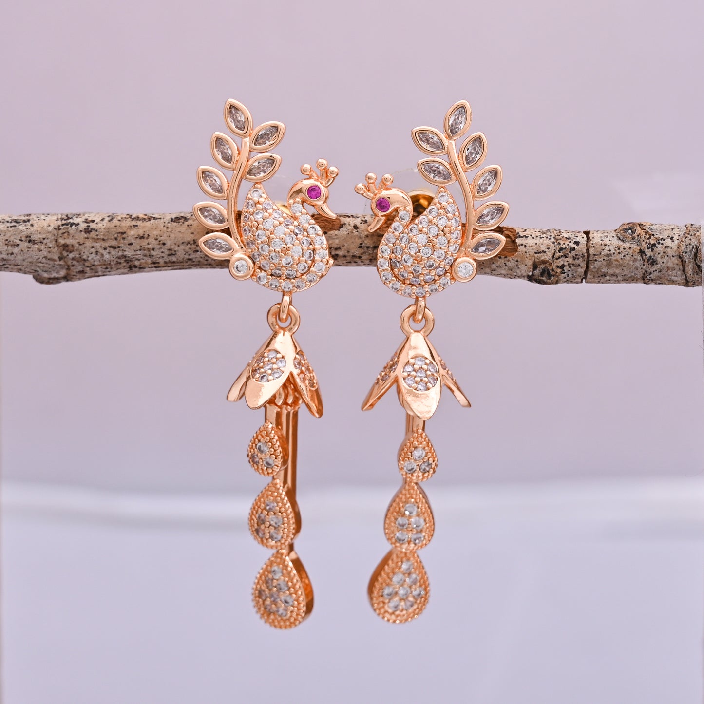 CKLAKART's Rose Gold Toned Peacock Danglers Enhanced with Shimmering AD