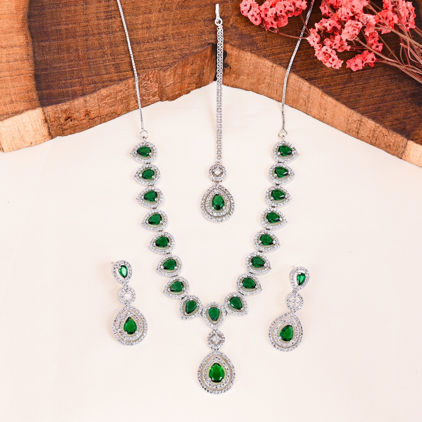 CKLAKART's NOOR Silver-Toned Necklace and Maang Tika Set Adorned with Emerald Green Stones and Dazzling American Diamonds