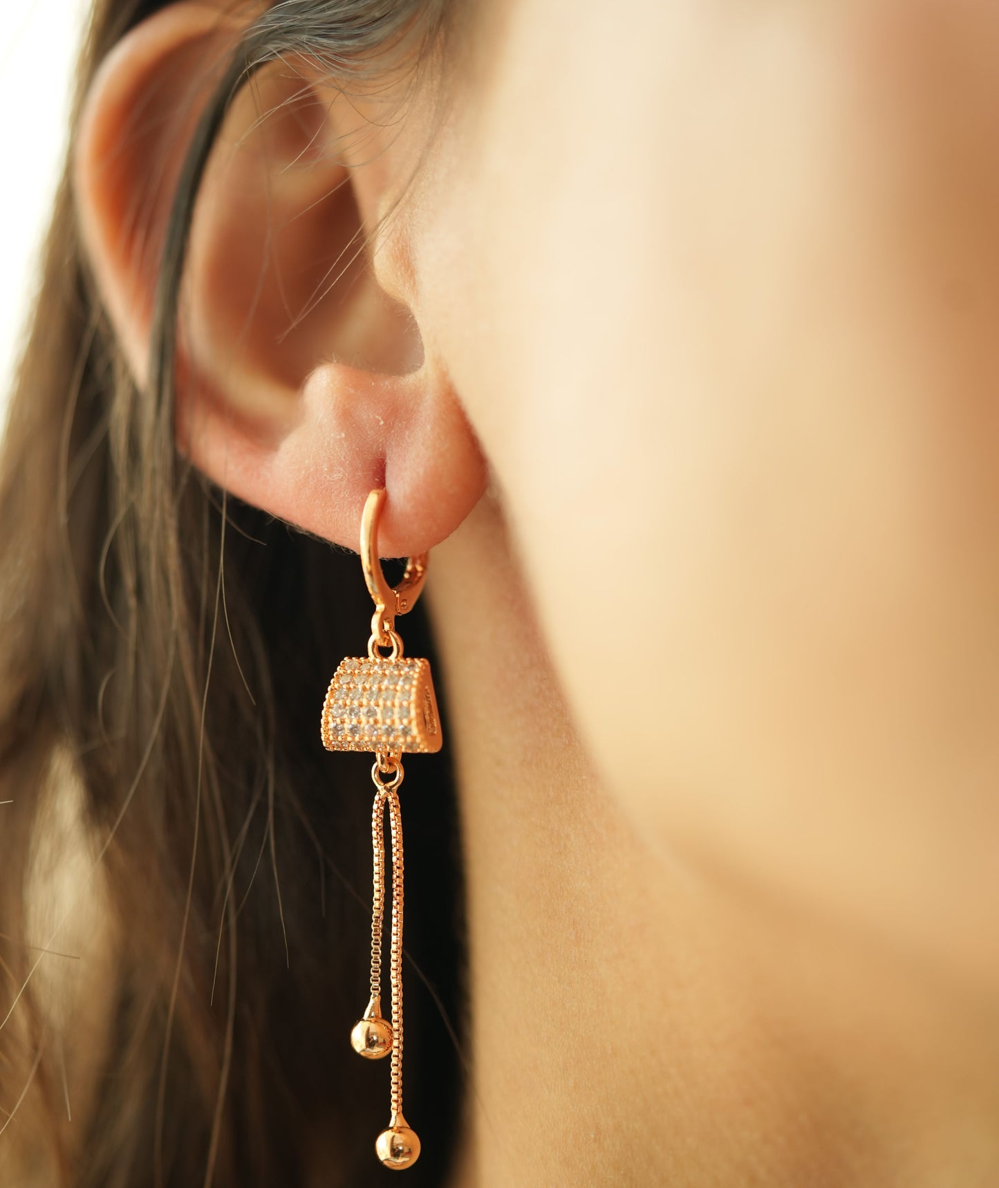 CKLAKART's Rose Gold Toned Earrings with AD Studded Clutch and Dangling Chains