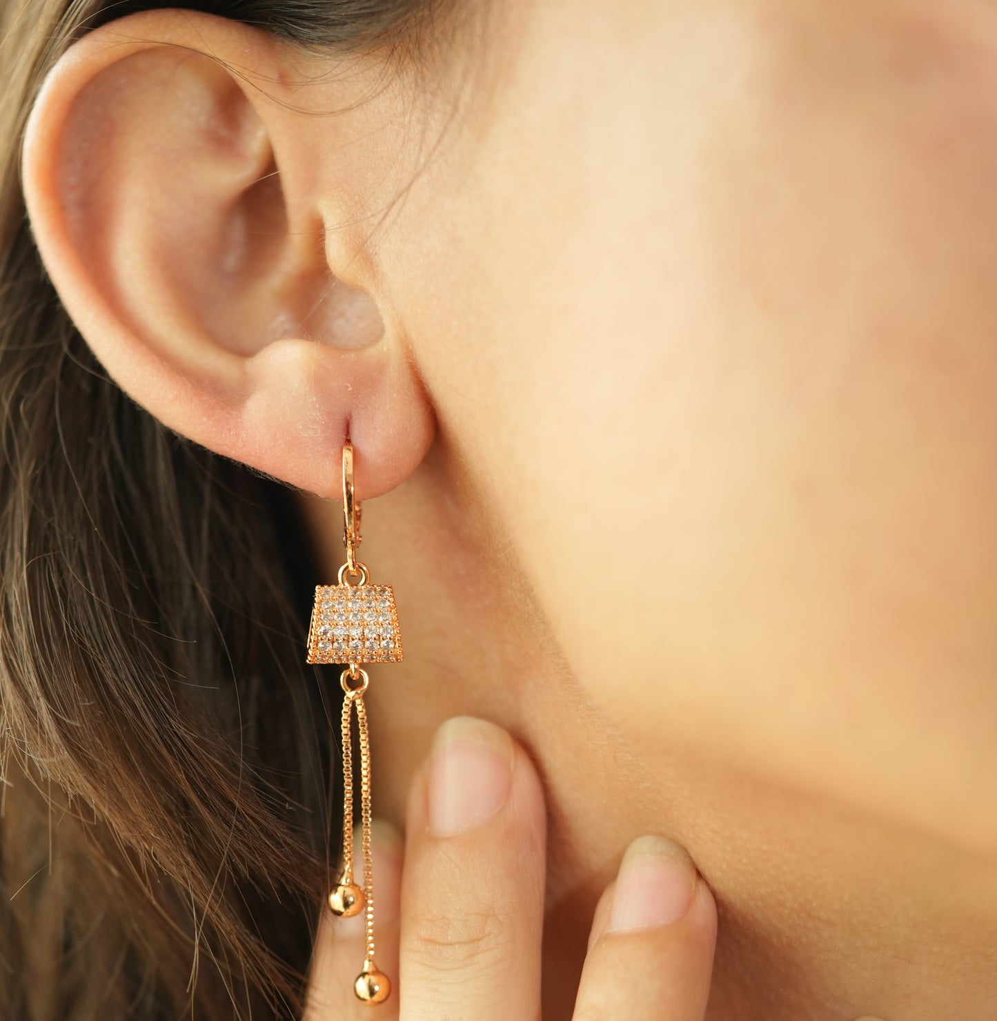 CKLAKART's Rose Gold Toned Earrings with AD Studded Clutch and Dangling Chains