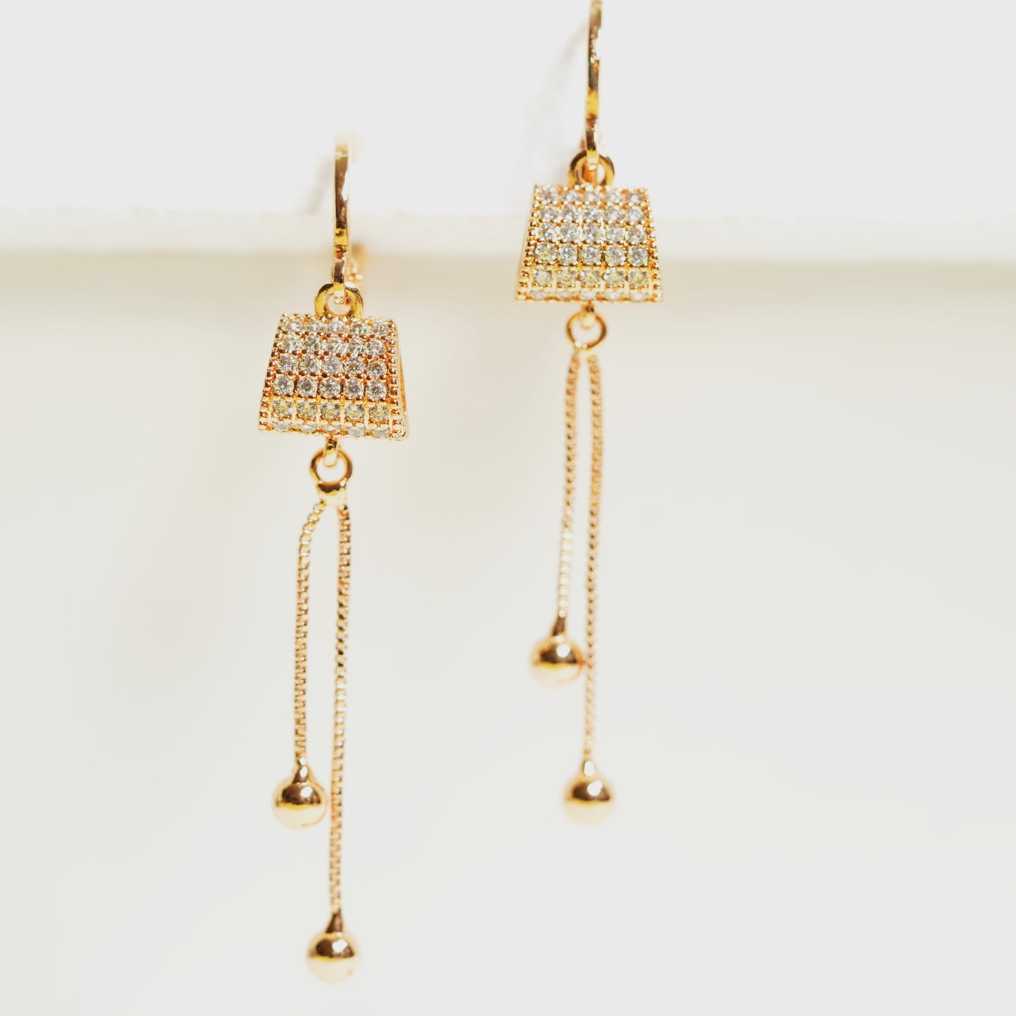 CKLAKART's Rose Gold Toned Earrings with AD Studded Clutch and Dangling Chains